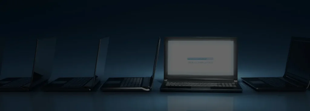 Dark image of a series of laptops with one facing forward showing page load progress.